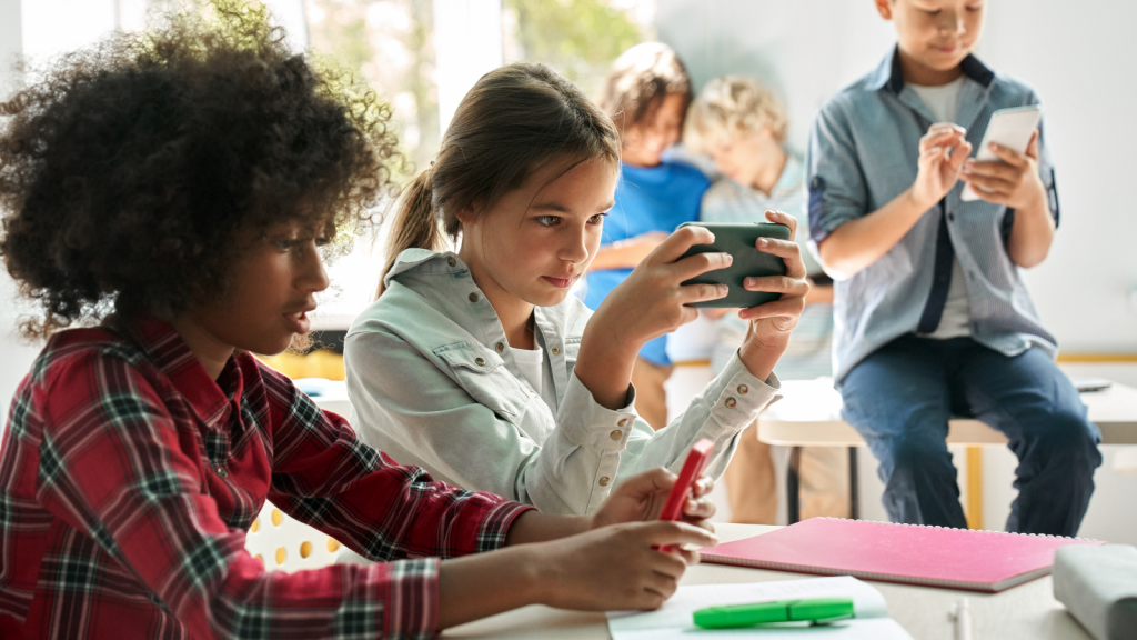 Diverse-multiethnic-kids-using-smartphones-in-classrooms