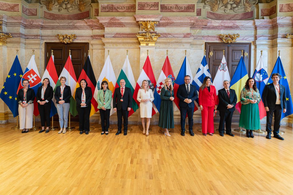The minister signatories are pictured together in front of their respective flags.