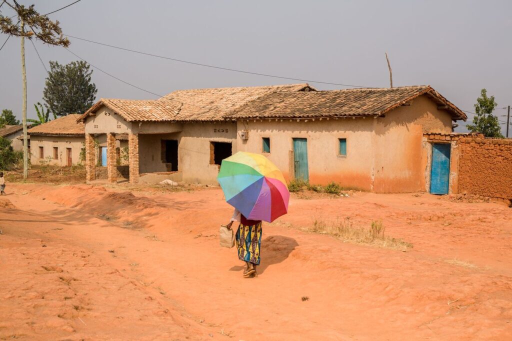 Woman walking with a rainbow umbrella