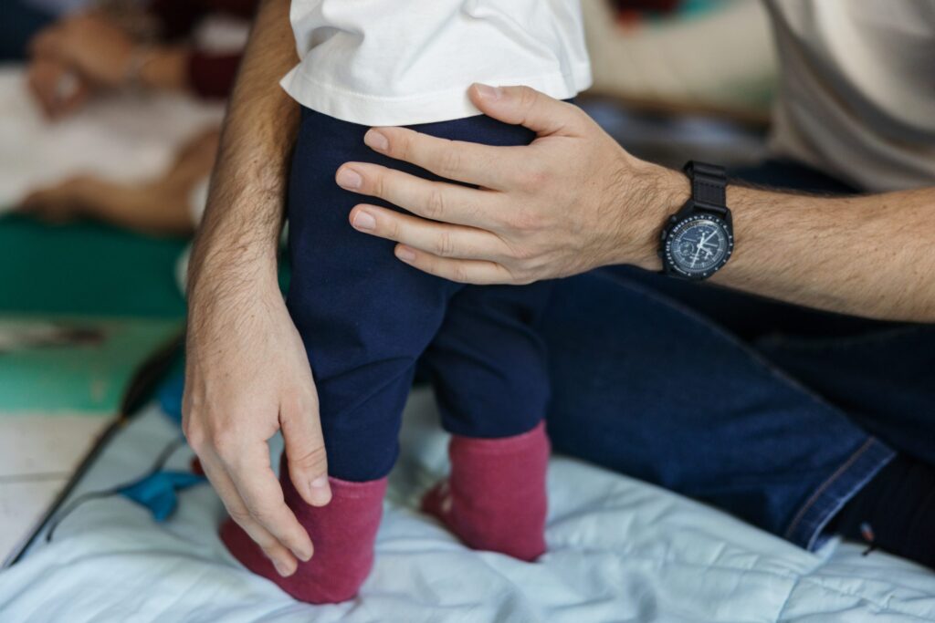 A mans hand holding a child.