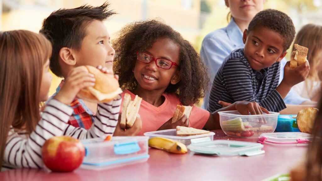 Children eating their school lunch together.