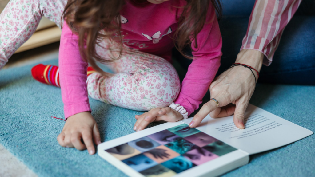 Children reading a book with an adult
