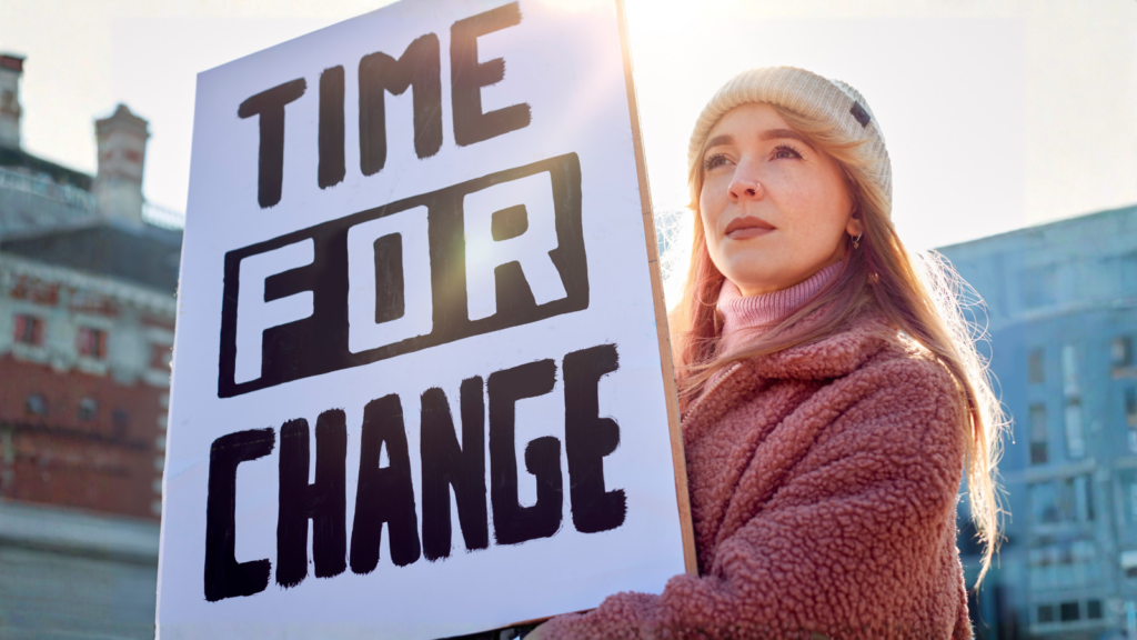 Girl holding poster "time for change".